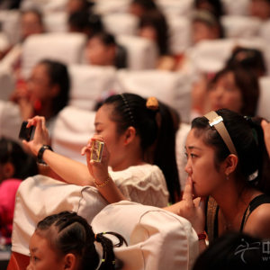 观众在认真听讲时，不忘拍照留念